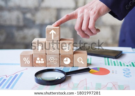 Business process management, Businessman plan a project with wooden cubes with icon business strategy on blurred background.