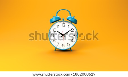 blue retro alarm clock on orange background
