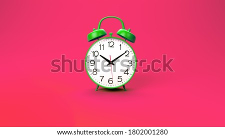 green retro alarm clock on pink background