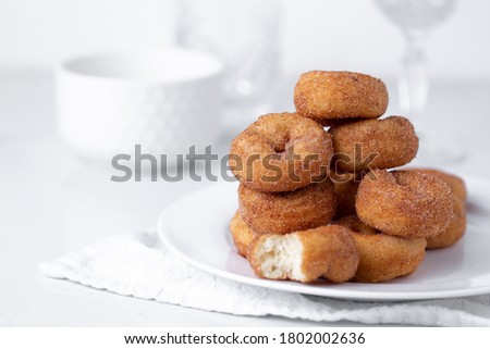Cinnamon sugar mini donuts on a white background Royalty-Free Stock Photo #1802002636