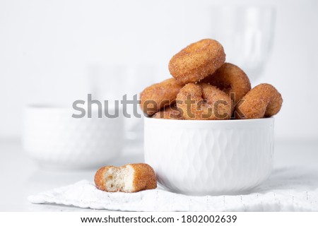 Cinnamon sugar mini donuts on a white background Royalty-Free Stock Photo #1802002639