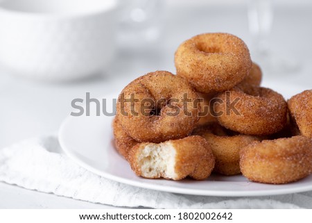 Cinnamon sugar mini donuts on a white background Royalty-Free Stock Photo #1802002642