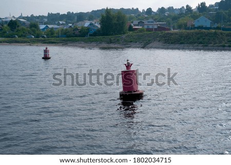Red River Buoy floating in the Volga river. Concept o navigation signs. Selective focus.
