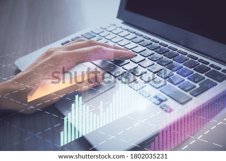 Double exposure of woman hands typing on computer and forex chart hologram drawing. Stock market analysis concept.