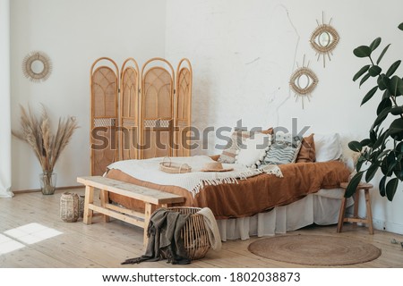 Bedroom interior in Bohemian style with patterned bed. Home interior detail in Boho style Royalty-Free Stock Photo #1802038873