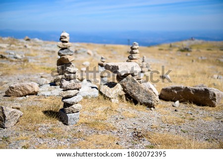 Stones pyramid on sand symbolising zen, harmony, balance. Selective focus.