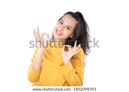 Asian young woman showing okay gesture on isolate white background