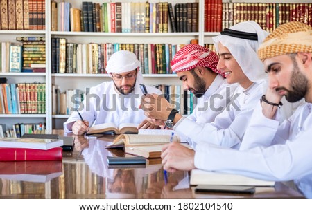 Group of arabic friends studying for exams in college