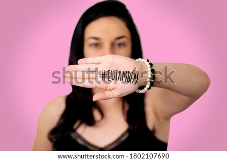 woman on pink background with palm of hand written # me too on pink background