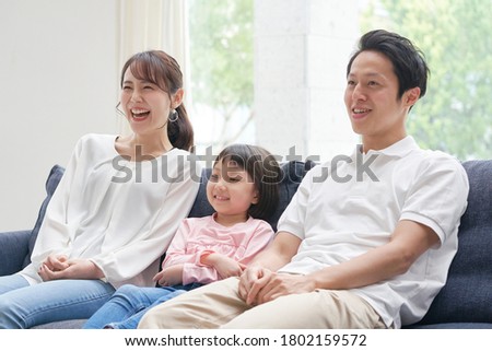 the smiling  parents and daughter