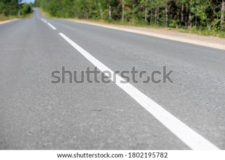 White dividing line on the asphalt road.