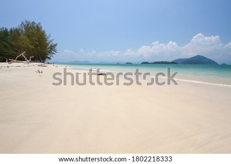 Tropical island with white sand beach and clear sea. Beautiful seascape at Koh Kam or Kam Island in Ranong province, Thailand.