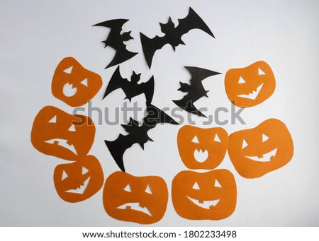 Orange funny pumpkins and bats on a white background.The Concept Of Halloween
