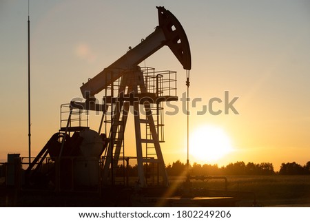 Oil Pump on orange sunset.