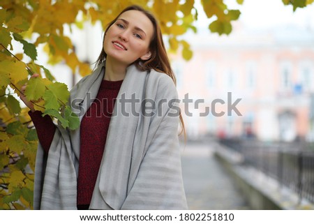 Young girl on a walk in the autumn park with an umbrella
