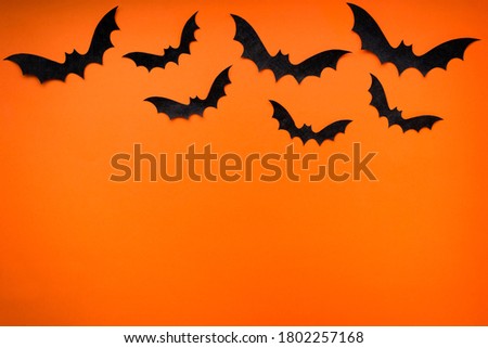 black bats on bright orange background
