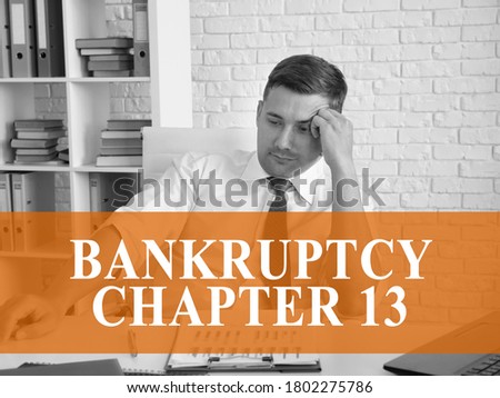 Bankruptcy chapter 13 concept. A pensive businessman is sitting at the table. Royalty-Free Stock Photo #1802275786