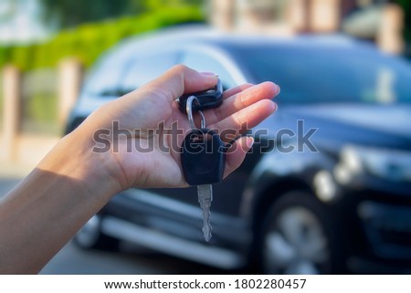 Woman holds the car keys. Concept on the topic of buying and renting a automobile