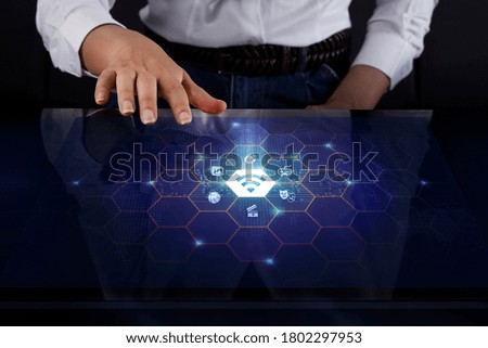 Business woman touching digital screen about Wifi and Entertainment icons