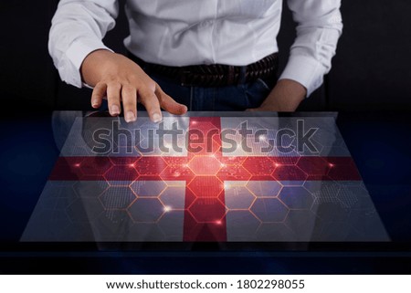 Business woman touching screen with England flag