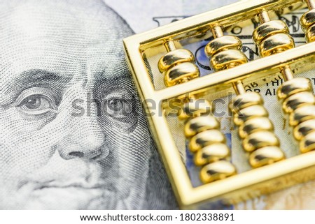 Long term investment for sustainable dividend growth, financial concept : Golden abacus on US dollar note, depicts investor invest or makes a saving plan in assets for capital gain and tax incentives Royalty-Free Stock Photo #1802338891
