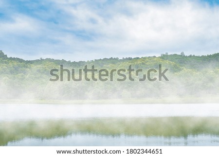 nature background of lake with fog in the morning, reflection on the water, natural landscape background with copy space for text