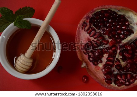 Honey jar, pomegranate, fresh apple. Rosh Hashanah (Jewish New Year holiday) concept.
