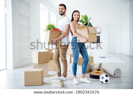 Full length body size view of  couple holding in hands stuff package settling down at place space flat light white interior house indoors Royalty-Free Stock Photo #1802361676