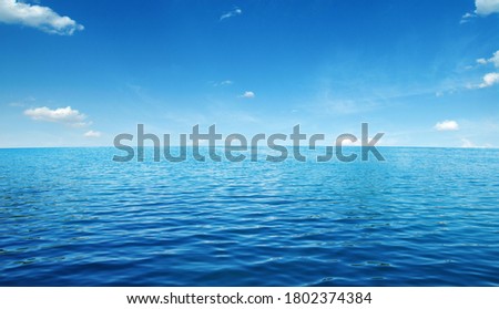 Blue sea water surface on sky Royalty-Free Stock Photo #1802374384