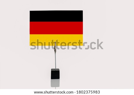 Federal Republic of Germany  miniature flag in cube base in photograph holder on a white background