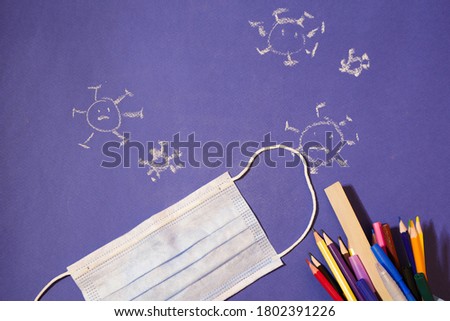 Protective Face mask with stationary flat lay. Virus picture. Back to school. Child drawings.New normal concept 