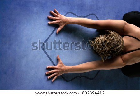 Young athletic woman doing breathing exercises, and a relaxing pose. Child's pose. Horizontal photography. Health and yoga concept.