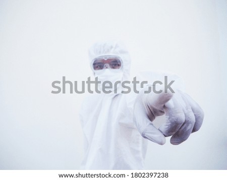 Asian doctor or scientist in PPE suite uniform showing pointing forward and while looking ahead. coronavirus or COVID-19 concept isolated white background