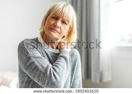 Sick senior adult elderly women touching the neck have shoulder and neck pain.Healthcare and medicine concept Royalty-Free Stock Photo #1802402650