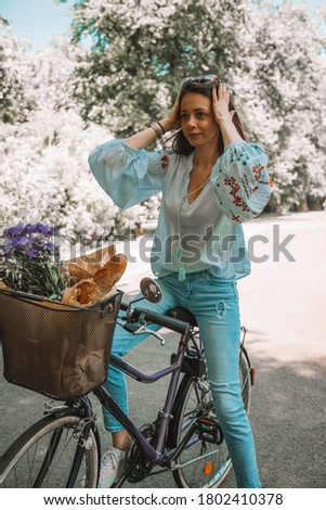  Attractive beautiful woman riding a bicycle in nature.