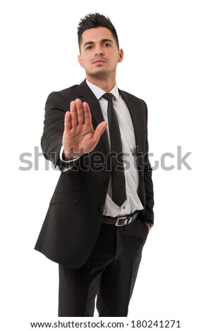 Business man wearing a classic black suit is  saying stay right there by using his right hand