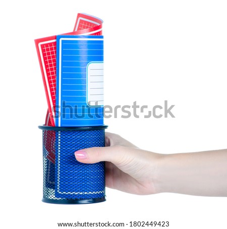 Hand holding school exercise book in stand on white background isolation