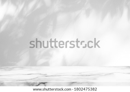 White Marble Table with Tree Shadow on Concrete Wall Texture Background, Suitable for Product Presentation Backdrop, Display, and Mock up.