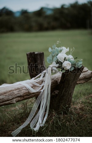 Wedding Day or Valentine's day Colorful white pastel Roses in a brides flower bouquet laid on the long grass field, Wedding flowers, bridal bouquet