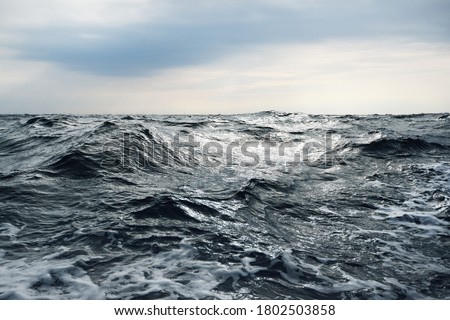 Glowing clouds above the open Baltic sea before the thunderstorm. Sweden Dramatic sky, epic seascape. A view from the yacht. Sailing in a rough weather Royalty-Free Stock Photo #1802503858