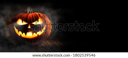 Halloween pumpkin head jack-o-lantern on dark background