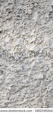 Abstract background of white rough plaster wall texture on fence wall.