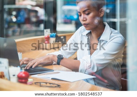 Business woman working behind glass stock photo