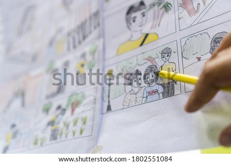 Director handwriting film storyboard or shooting board, Screenplay, dialog and language for film or television with characters, Scripted sequence, predefined series of events, pre-production in studio