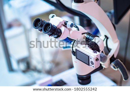 Operating microscope with built-in camera. Dental operating microscope. Dental optics. Dental equipment. Dentistry. Equipment for complex operations. Royalty-Free Stock Photo #1802555242