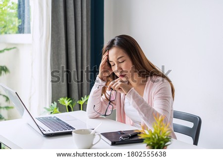 Stressed young woman calculating monthly home expenses, taxes, bank account balance and credit card bills payment, Income is not enough for expenses.