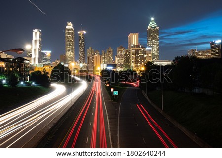 Jackson Street Bridge in Atlanta with a long exposure showing traffic and a plane.