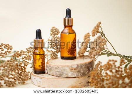 Dropper glass bottle skincare essential oil products for mock up in minimal style with on pastel cream background.