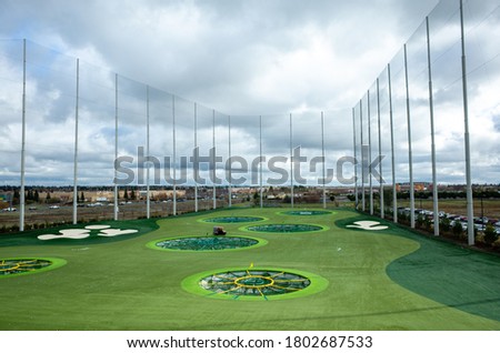 golfing range with cloudy skies 