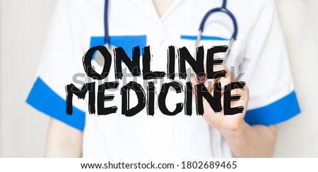 Doctor writting text ONLINE MEDICINE with marker,medical concept